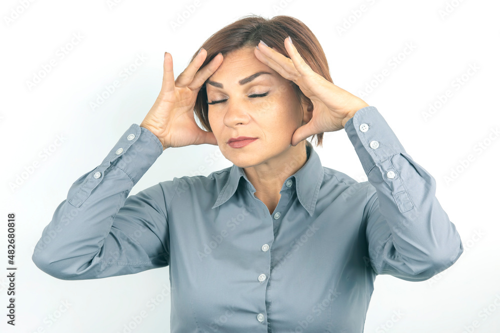Beautiful young business woman with closed eyes thinks over her project on a white background. thoughts and stress. relaxation and emotions Beautiful young business woman with closed eyes thinks over her project on a white background. thoughts and stress. relaxation and emotions