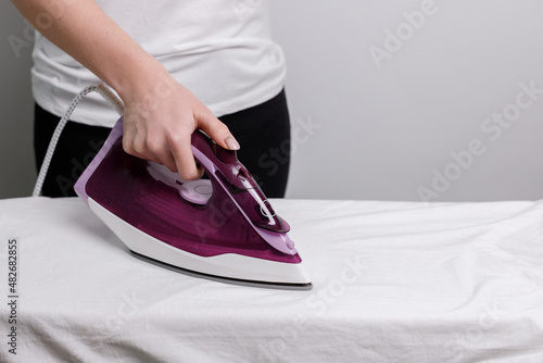 woman ironing close-up with iron