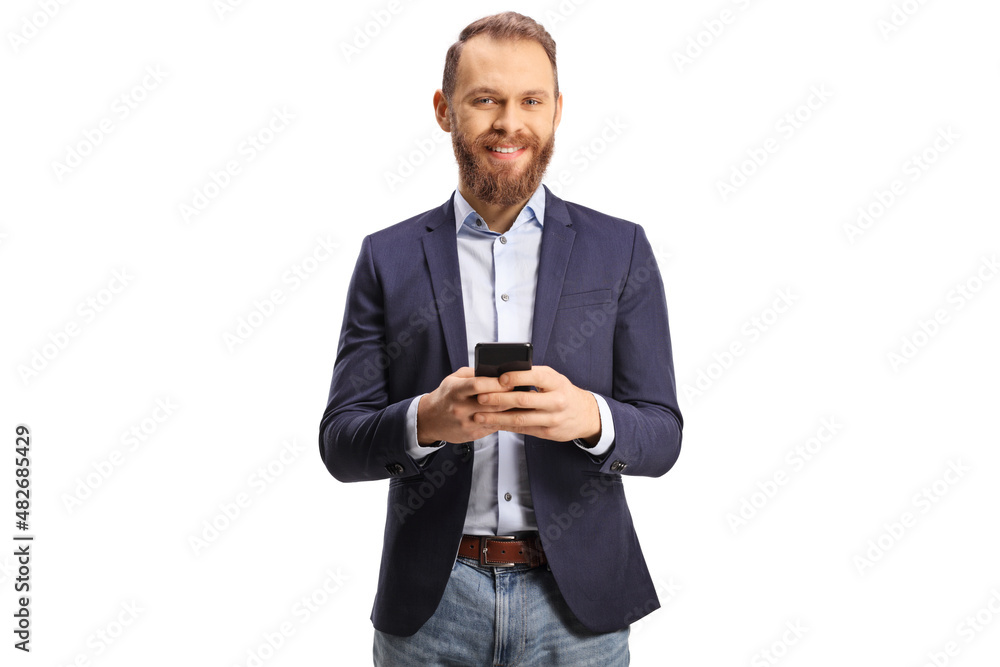 Bearded guy in suit and jeans using a mobile phone and smiling Bearded guy in suit and jeans using a mobile phone and smiling