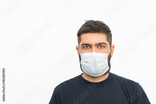 A young man with a beard and masks. Security measures. Masked man. Isolated background.