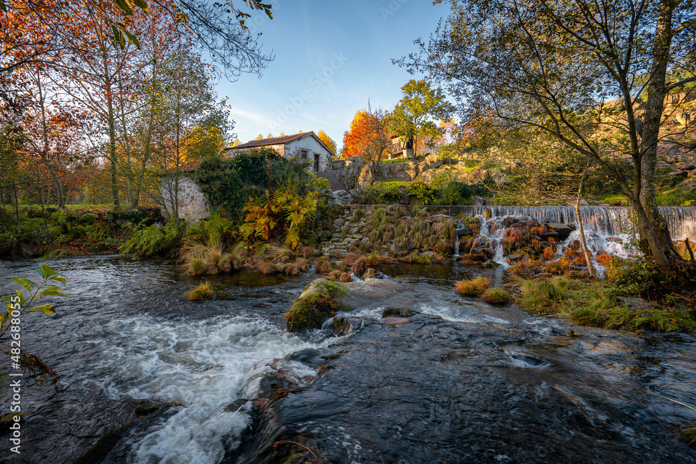 Mondim de Basto waterfall with a mill house at sunset in Portugal Mondim de Basto waterfall with a mill house at sunset in Portugal