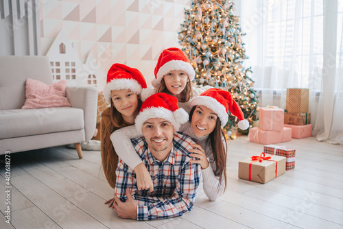 Happy young family with kids holding christmas presents