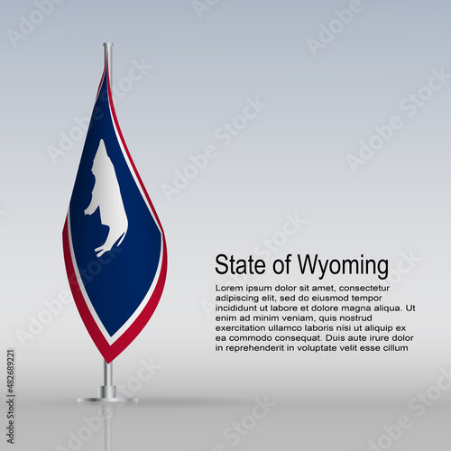 Flag of State of Wyoming (USA) hanging on a flagpole stands on the table photo