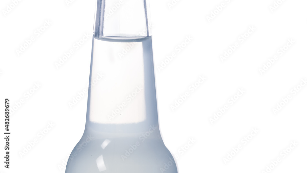 A glass bottle and a transparent drink on a light background, the concept of refreshing with a refreshing liquid A glass bottle and a transparent drink on a light background, the concept of refreshing with a refreshing liquid