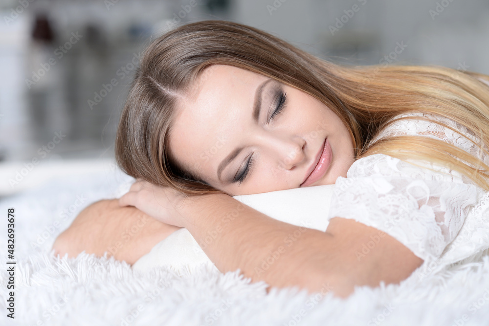 Portrait of young beautiful woman sleeping in bed at home