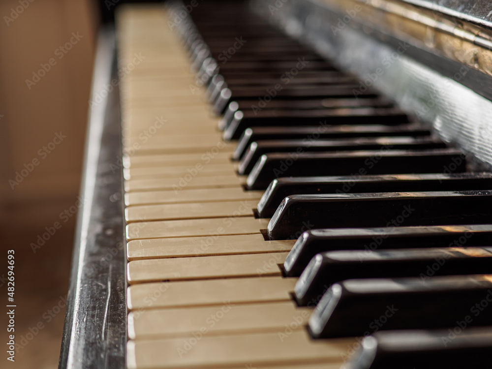 Close side view of shiny black and white old piano keys. Close side view of shiny black and white old piano keys.