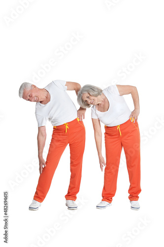 Senior couple exercising isolated on white background