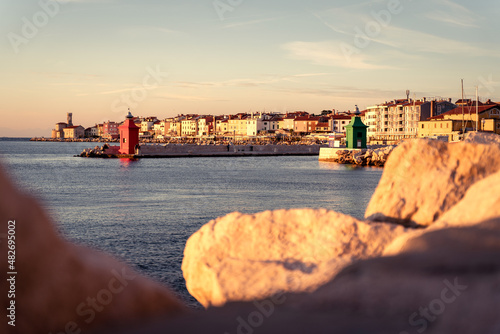 Piran Pirano sea port sunset, red and green lighthouse, pier, Slovenia Slovenija coast, Adriatic sea, Istria