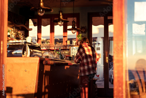 Young girl in a cafe, sunset warm colors, buying drinks, autumn fall cozy vibes, Piran, Pirano, Istria, Slovenia, Slovenija