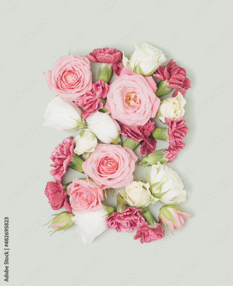 Spring flowers arranged on a pastel green background. Blooming retro spring flat lay.