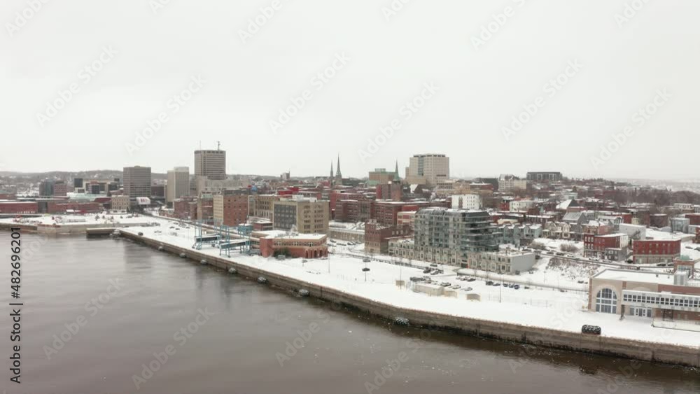 Aerial view flying over the waterfront in uptown Saint John, New Brunswick on a snowy, winter day. Aerial view flying over the waterfront in uptown Saint John, New Brunswick on a snowy, winter day.