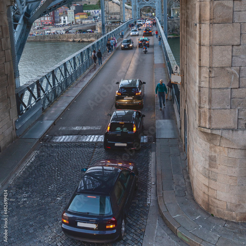 Cars drive on a road bridge across the Douro River in the Portuguese city of Porto