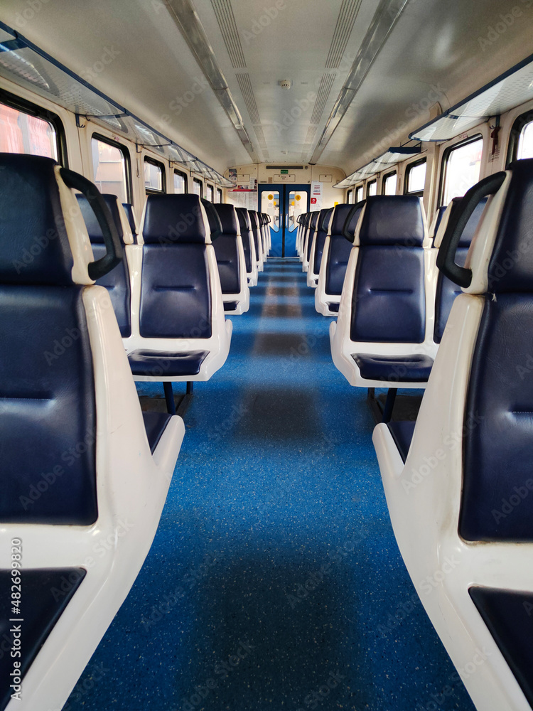 a symmetrical Vertical photo inside of empty seated carriag in clean modern train a symmetrical Vertical photo inside of empty seated carriag in clean modern train