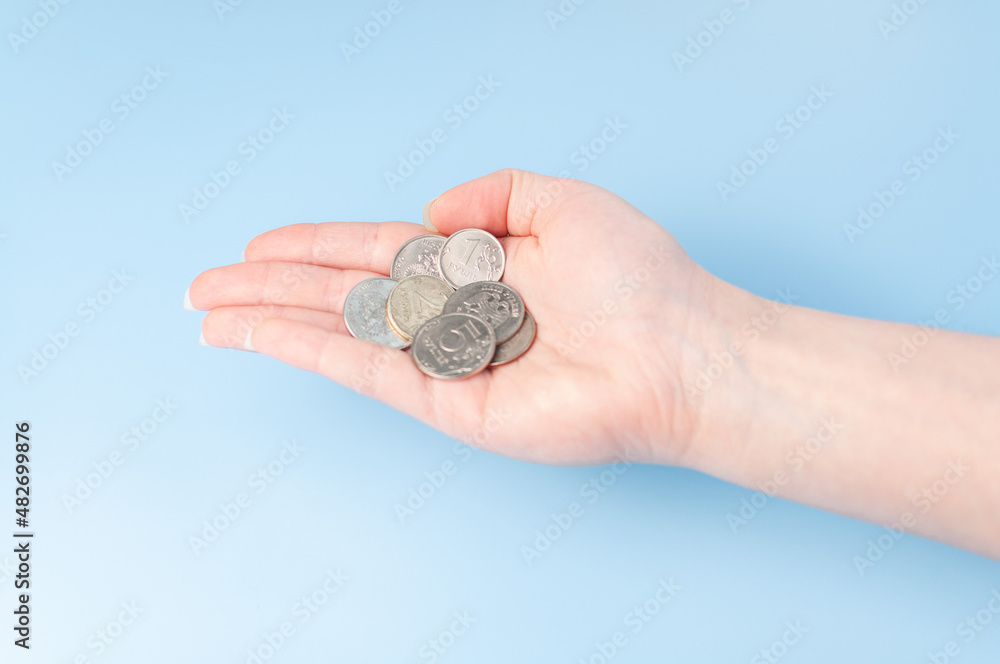 A small woman hand with russian coins. Hand with money. Budget. Go shopping. A small woman hand with russian coins. Hand with money. Budget. Go shopping.
