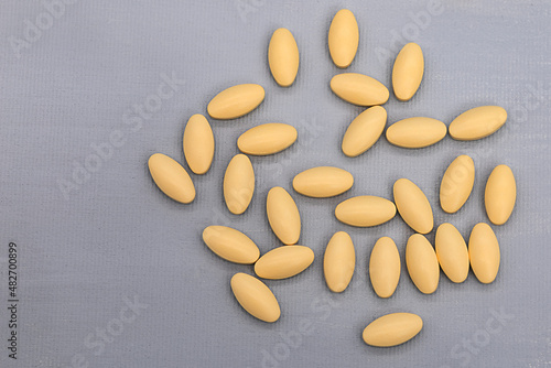 oval-shaped tablets lie on a contrasting background