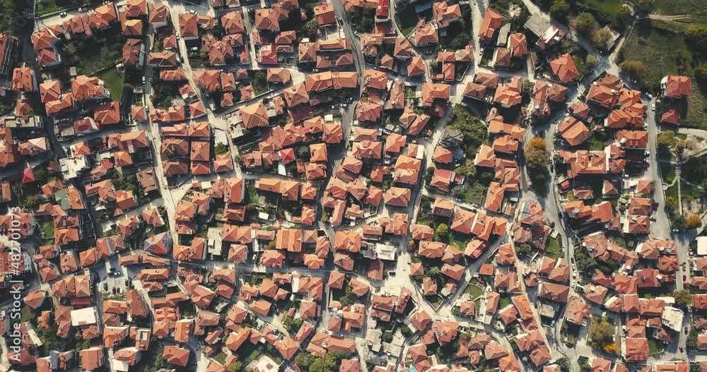 Video of a drone flying over the traditional red roofs of a resort town or village. The concept of real estate and travel in Europe Video of a drone flying over the traditional red roofs of a resort town or village. The concept of real estate and travel in Europe