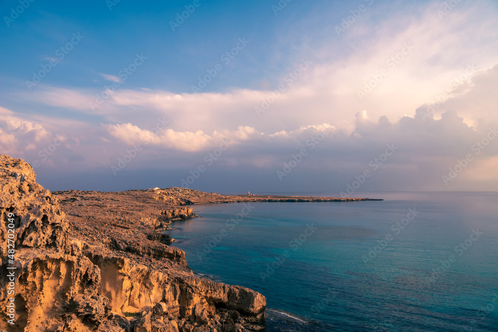 View of rocky coast and beautiful sky near Cape Greco, Ayia Napa, Cyprus.