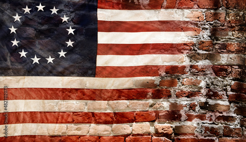 Betsy Ross flag with 13 stars on brick wall photo