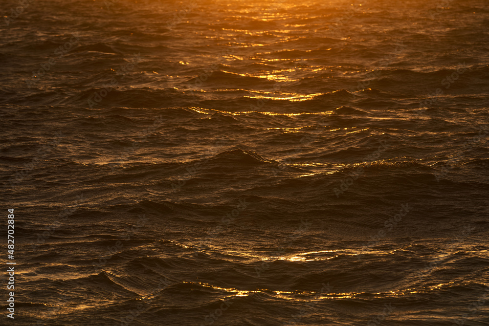 Sunlight reflected in sea waves at sunrise Sunlight reflected in sea waves at sunrise