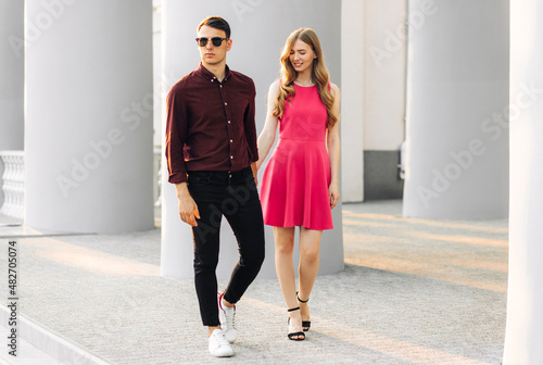couple in love, dating in the city outdoors. Romantic couple walking in the city holding hands, February 14