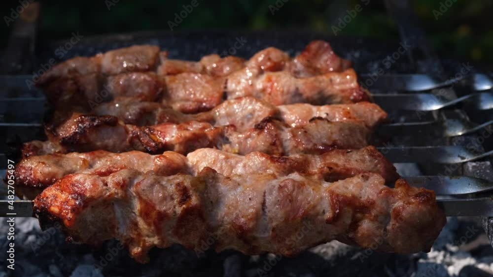 shish kebab close-up of meat, grilled meat, shish kebab from grilled meat with smoke, the process of roasting on the grill, shish kebab on skewers shish kebab close-up of meat, grilled meat, shish kebab from grilled meat with smoke, the process of roasting on the grill, shish kebab on skewers