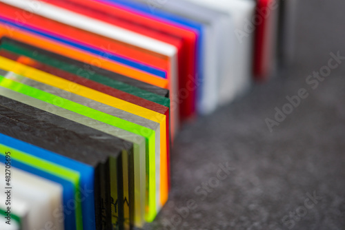 Multi-colored samples of organic glass. Colorful acrylic sheets plastic swatches, craft and decoration equipment photo