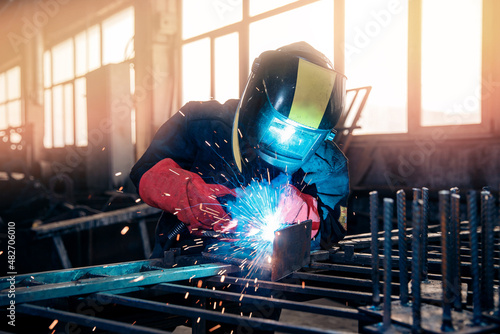 Fotografie Factory industry worker welder in protective uniform with mask on workplace meta