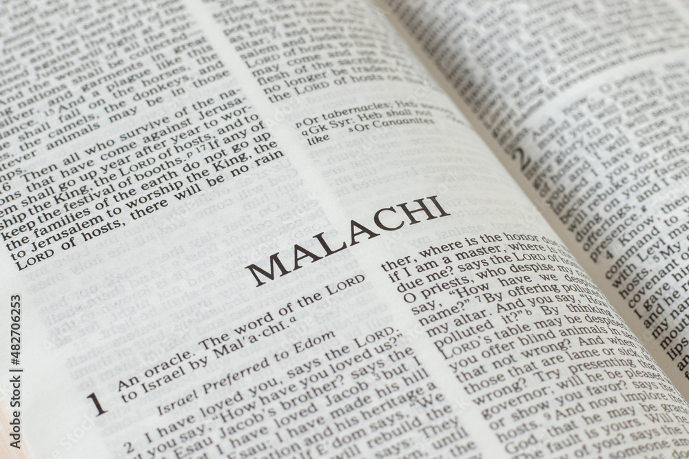 Malachi open Holy Bible Book close-up. Old Testament Scripture prophecy. Studying the Word of God Jesus Christ. Christian biblical concept of faith, hope, and trust. Malachi open Holy Bible Book close-up. Old Testament Scripture prophecy. Studying the Word of God Jesus Christ. Christian biblical concept of faith, hope, and trust.