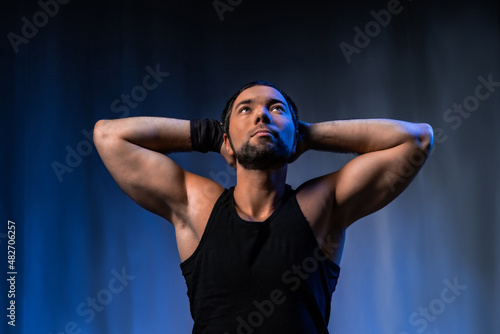 muscular man. athlete posing in a black T-shirt and jeans. studio portrait © Ольга Новицкая