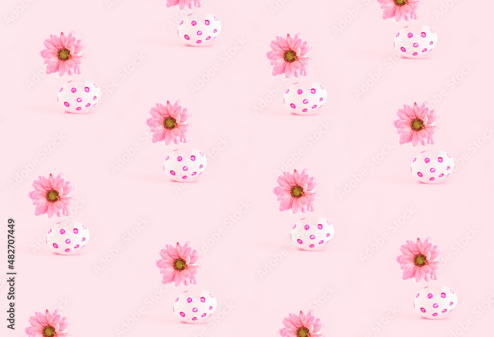 Cute spring inspired pattern against pastel pink background. Eggshells and daisy flowers. 