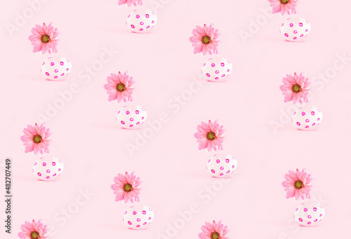 Cute spring inspired pattern against pastel pink background. Eggshells and daisy flowers. 