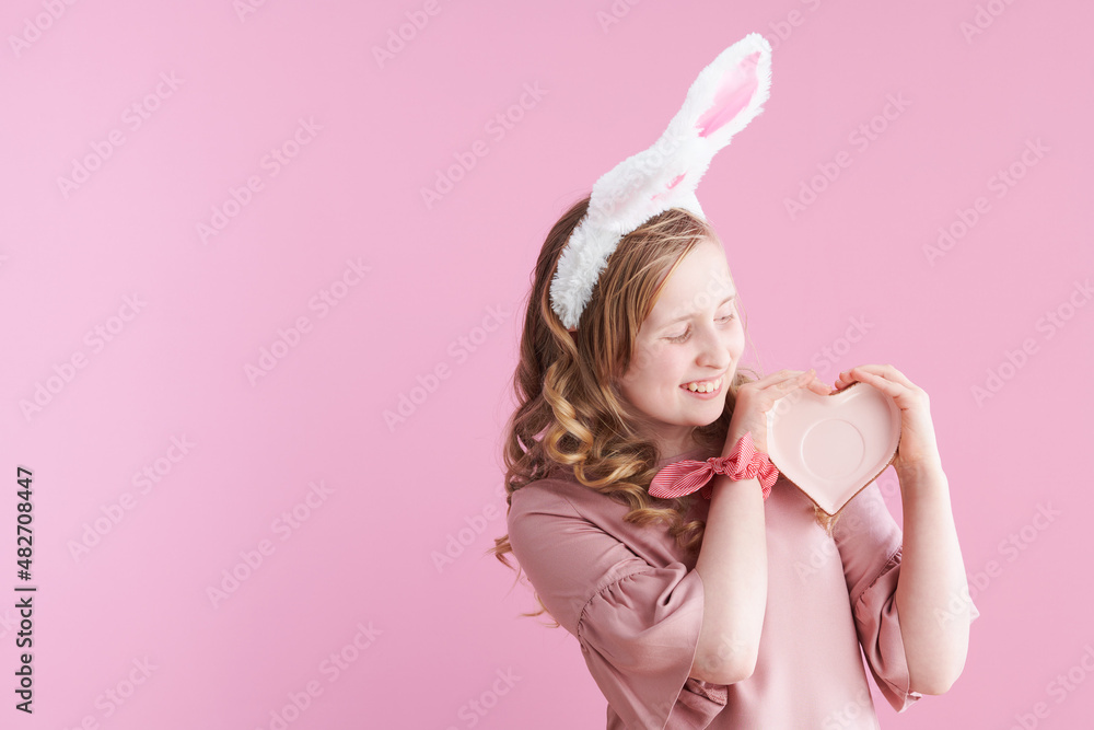 happy modern girl with long wavy blond hair on pink happy modern girl with long wavy blond hair on pink