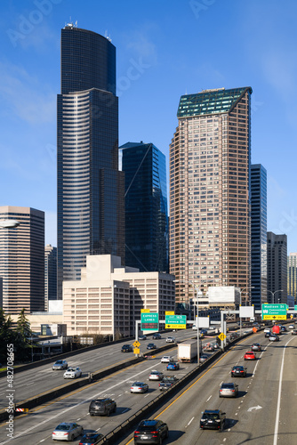 Seattle - January 22, 2022; Traffic on Interstate 5 passes downtown Seattle skyscrapers under a blue sky