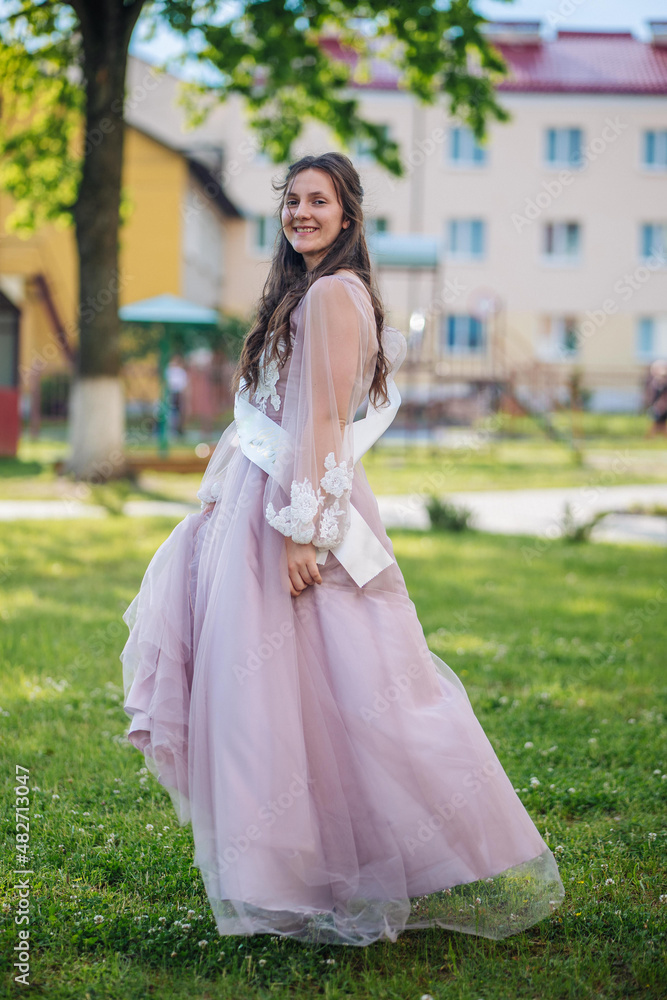 Beautiful schoolgirl in dress at the prom at school. Beautiful schoolgirl in dress at the prom at school.
