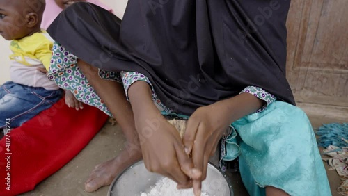 african girl grating coconut