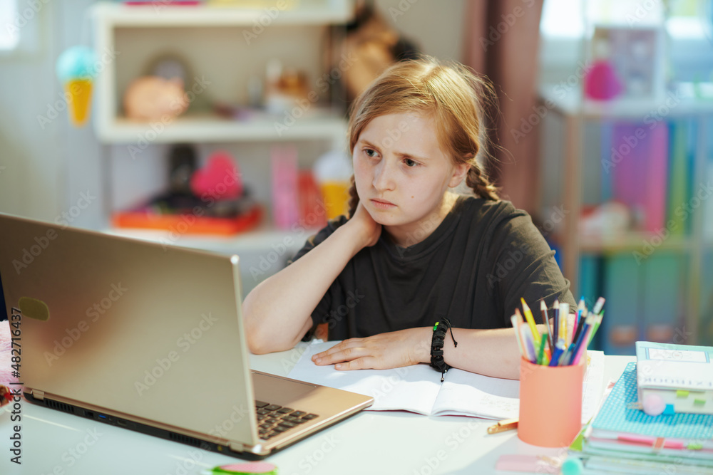 sad modern pupil having online education at home in sunny day sad modern pupil having online education at home in sunny day
