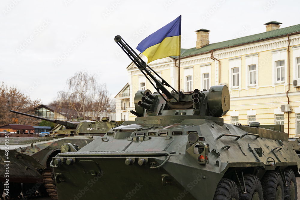Army troops transporter and tank with Ukrainian flag, Ukraine - Russia war crisis concept, Kyiv