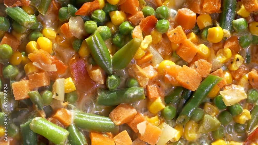 Vegetable stew. A dish of frozen vegetables is cooked in a frying pan. Asparagus, corn, pepper, peas. Vegetable stew. A dish of frozen vegetables is cooked in a frying pan. Asparagus, corn, pepper, peas.