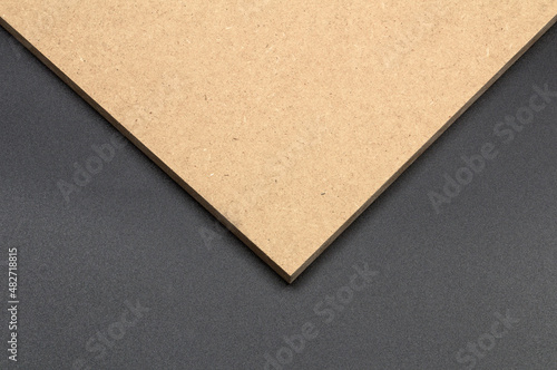 Raw mdf board on black background.