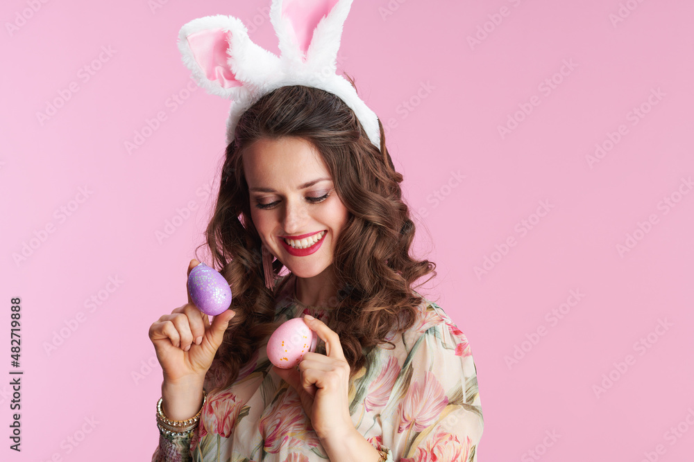 young woman with long wavy brunette hair on pink young woman with long wavy brunette hair on pink