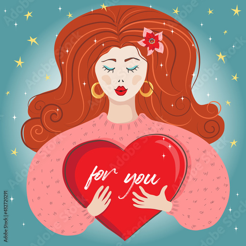 Ragazza innamorata con lunghi capelli rossi abbraccia un cuore di san Valentino photo