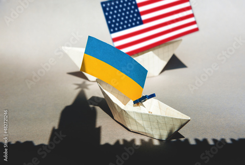 paper ships with flag of of Ukraine and Kremlin star Russia, relationships war conflict between the countries occupation of the territory photo