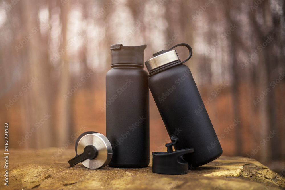 Black water bottle thermos in nature Stock Photo | Adobe Stock