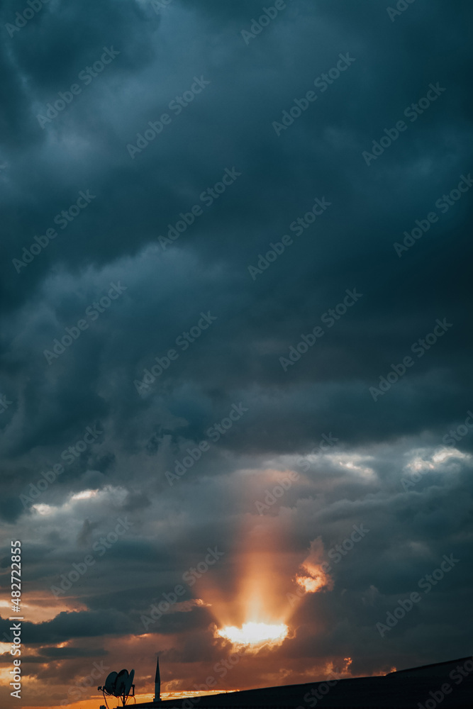 beam of light between clouds at cloudy sunset beam of light between clouds at cloudy sunset