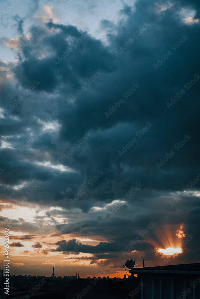 beam of light between clouds at cloudy sunset,dark sky beam of light between clouds at cloudy sunset,dark sky