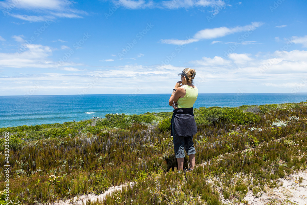 South Africa, Western Cape, Woman looking at ocean view in Lekkerwater Nature Reserve South Africa, Western Cape, Woman looking at ocean view in Lekkerwater Nature Reserve
