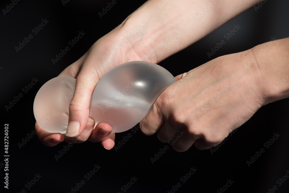 Silicone implant of the female breast during the demonstration of its quality. Silicone implant of the female breast during the demonstration of its quality.