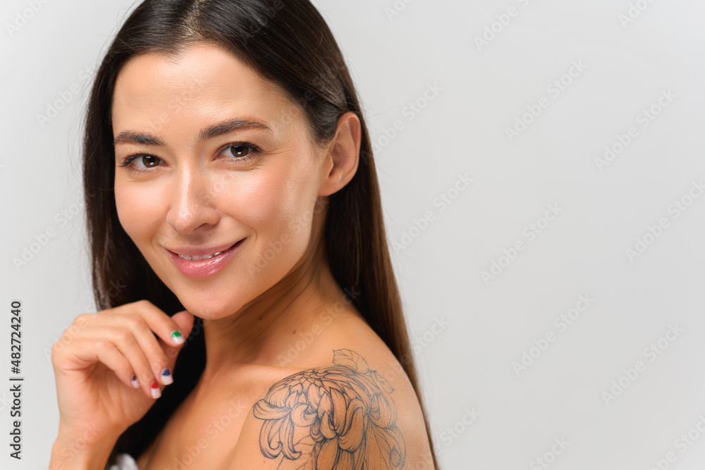 Portrait view of the beautiful asian woman with tattoo at her naked ...