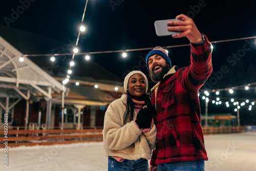 Couple taking selfie on ice rink