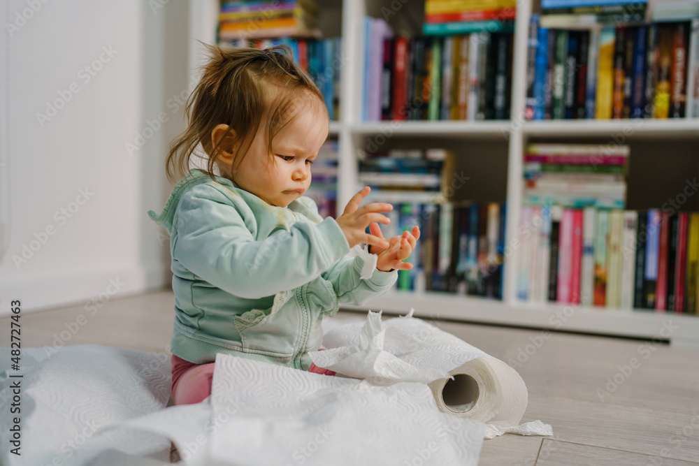 one caucasian baby girl making mess in the house playing and mischief with bad behavior ripping paper towel on the floor naughty kid at home childhood and growing up misbehavior concept one caucasian baby girl making mess in the house playing and mischief with bad behavior ripping paper towel on the floor naughty kid at home childhood and growing up misbehavior concept